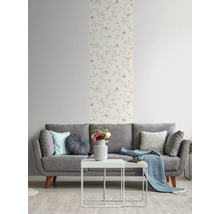 Woonkamer met grijze bank, witte tafel en bloemenbehang