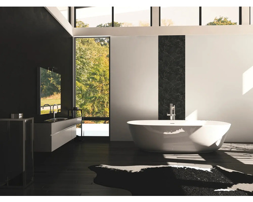 Moderne badkamer met vrijstaand bad, wastafel en groot raam.