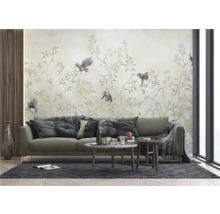 Woonkamer met bank, salontafel en behang met vogelmotief