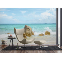 Woonkamer met fotobehang strandmotief, fauteuil, voetenbank en bijzettafel