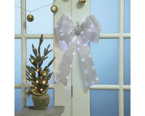 Kerstscène met versierde kerstboom en strik met lichtjes