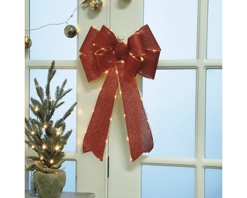 Decoratieve kerstversiering met strik en mini-kerstboom