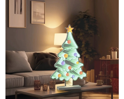 Decoratieve kerstboom met ster en ballen op tafel
