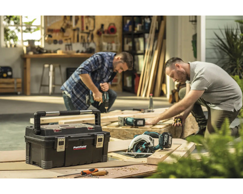 Werkplaatsopname met gereedschapskist, handzaag en twee ambachtslieden aan het werk