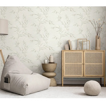 Lichte woonkamer met bladerbehang, zitzak, commode en bijzettafel