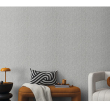 Close-up van een grijs vliesbehang met een fijne textuur