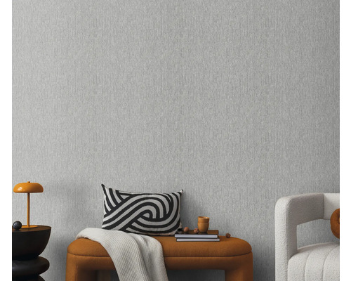 Close-up van een grijs vliesbehang met een fijne textuur