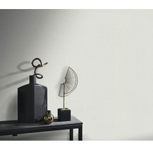 Close-up van een gestructureerde wand met decoratieve objecten op een plank.