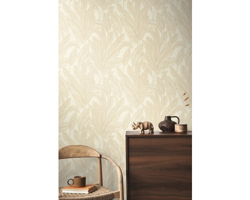 Een kamer met een wandbehang met bladerpatroon, een houten stoel en een donkere houten kast.