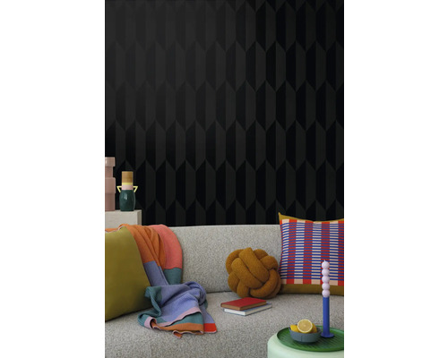 Woonkamer met zwart behang met geometrisch patroon en bank