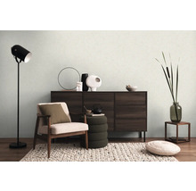 Woonkamer met fauteuil, dressoir, staande lamp en decoraties voor een gezellige sfeer.