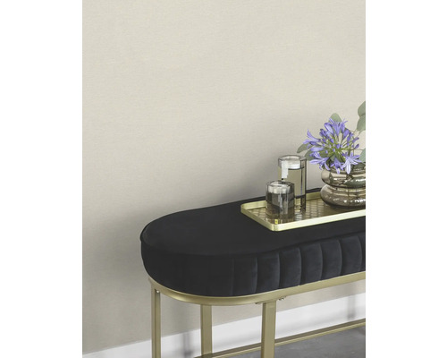 Decoratieve hocker met bloemen, glazen en een gouden dienblad.