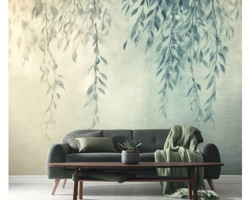 Woonkamer met bank en wandbehang met bladerenmotief