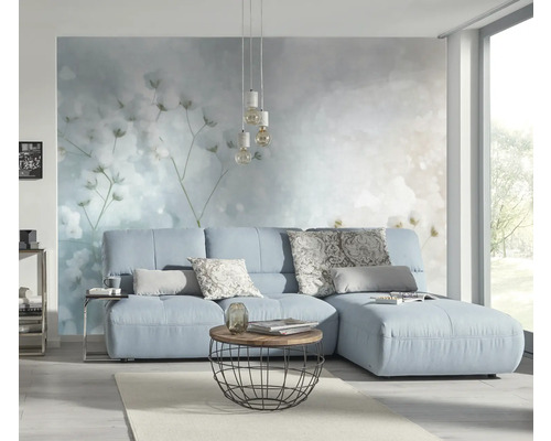 Lichte woonkamer met blauwe bank, salontafel en decoratief wandbehang