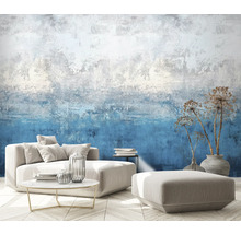 Woonkamer met patroonbehang, bank, kruk, tafel en decoratie