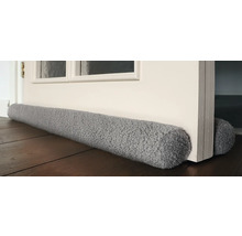 Tochtstopper van textiel voor een deur