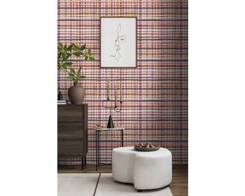 Woonkamerinterieur met geruite wandbekleding, ladekast, kruk en decoraties voor een gezellige sfeer.