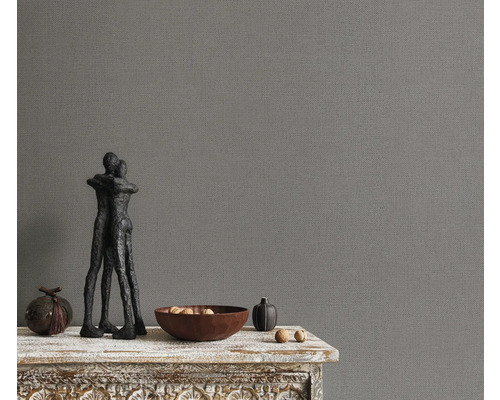 Grijze vinyl behang met textielstructuur en stilleven decoratie op een tafel