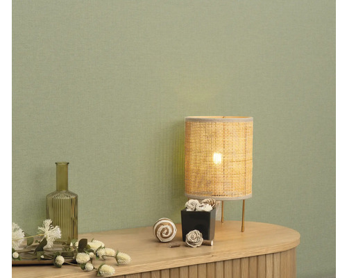 Decoratief interieur met tafellamp en accessoires op een dressoir voor een muur.