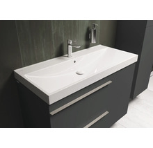 Wastafel met onderkast, kraan en zeepdispenser in de badkamer.