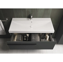 Wastafelonderkast met open lade, handdoeken en cosmetische producten in de badkamer