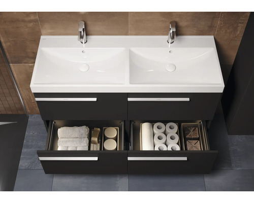 Dubbele wastafel met onderkast, open laden en badkamerbenodigdheden.