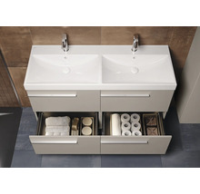 Wastafelmeubel met twee waskommen, kranen en open laden met handdoeken en toiletpapier