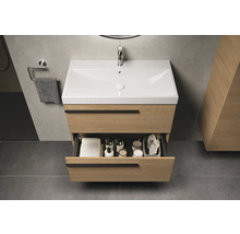 Badkamer met wastafelonderkast van hout, wastafel en open lade