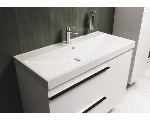 Witte wastafel met twee lades, kraan en zeepdispenser