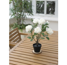 Decoratieve kunstmatige roos in pot op een houten tafel