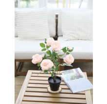 Decoratieve kunstmatige roos in pot op een houten tafel