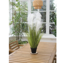 Decoratieve kunstplant met veren in een pot op een houten tafel