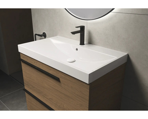 Wastafel met onderkast en kraan in de badkamer.