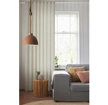 Woonkamer met grijze bank, houten bijzettafel en stoffen gordijn