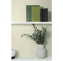 Decoratieve boeken en eucalyptus in vaas op een plank.