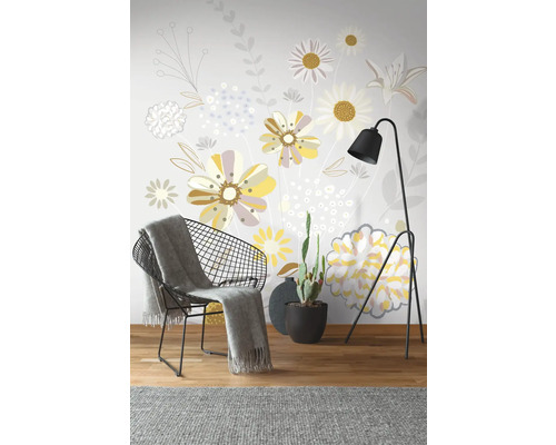 Decoratieve wanddecoratie met bloemmotief, fauteuil, staande lamp en cactus in pot.