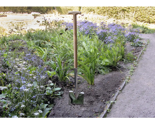 Spade met houten handvat in de tuin