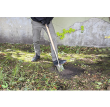 Persoon graaft met een spade in de tuin