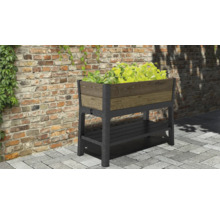 Verhoogde plantenbak met opbergruimte en beplanting voor een bakstenen muur