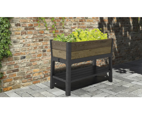 Verhoogde plantenbak met opbergruimte en beplanting voor een bakstenen muur