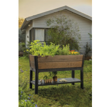 Houten en kunststof verhoogde plantenbak met opbergruimte in de tuin