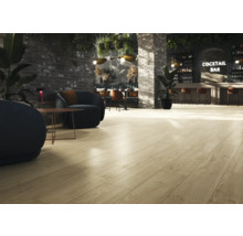 Interieur met lichte houten vloer, zithoek en bar op de achtergrond