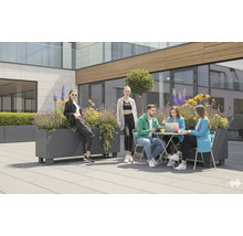 Mensen zitten en staan buiten aan tafels en plantenbakken.