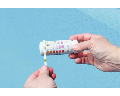 Een persoon test het zwembadwater met een teststrip en een testkit.