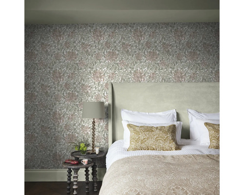 Slaapkamer met bloemenbehang, bed, nachtkastje en lamp