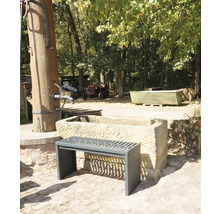 Buitenscène met een bank voor een stenen trog