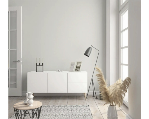 Lichte woonkamer met dressoir, staande lamp en decoratie