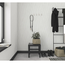 Entree met patroonbehang, kapstok en decoratieve elementen voor een georganiseerde en stijlvolle eerste indruk.