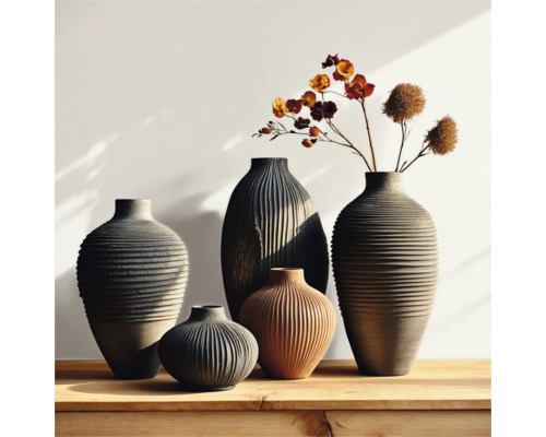 Groep geribbelde vazen in verschillende groottes en vormen op een houten tafel, sommige met bloemaccenten.