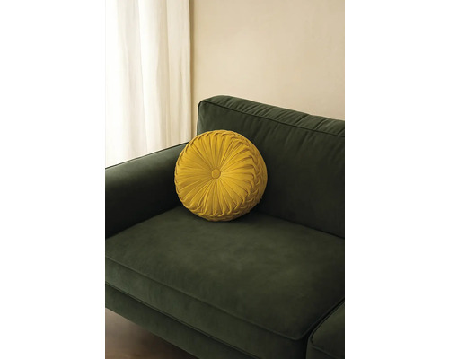 Rond decoratief kussen op een bank